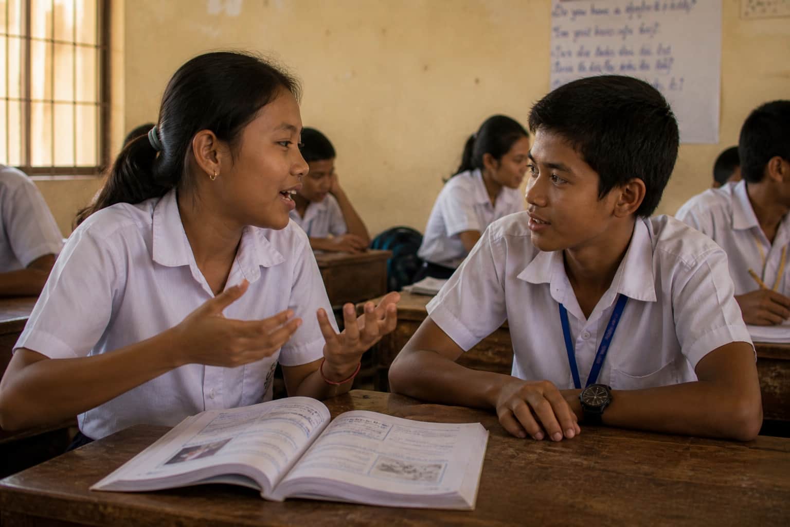 Two students using grammar in real conversation in pair work