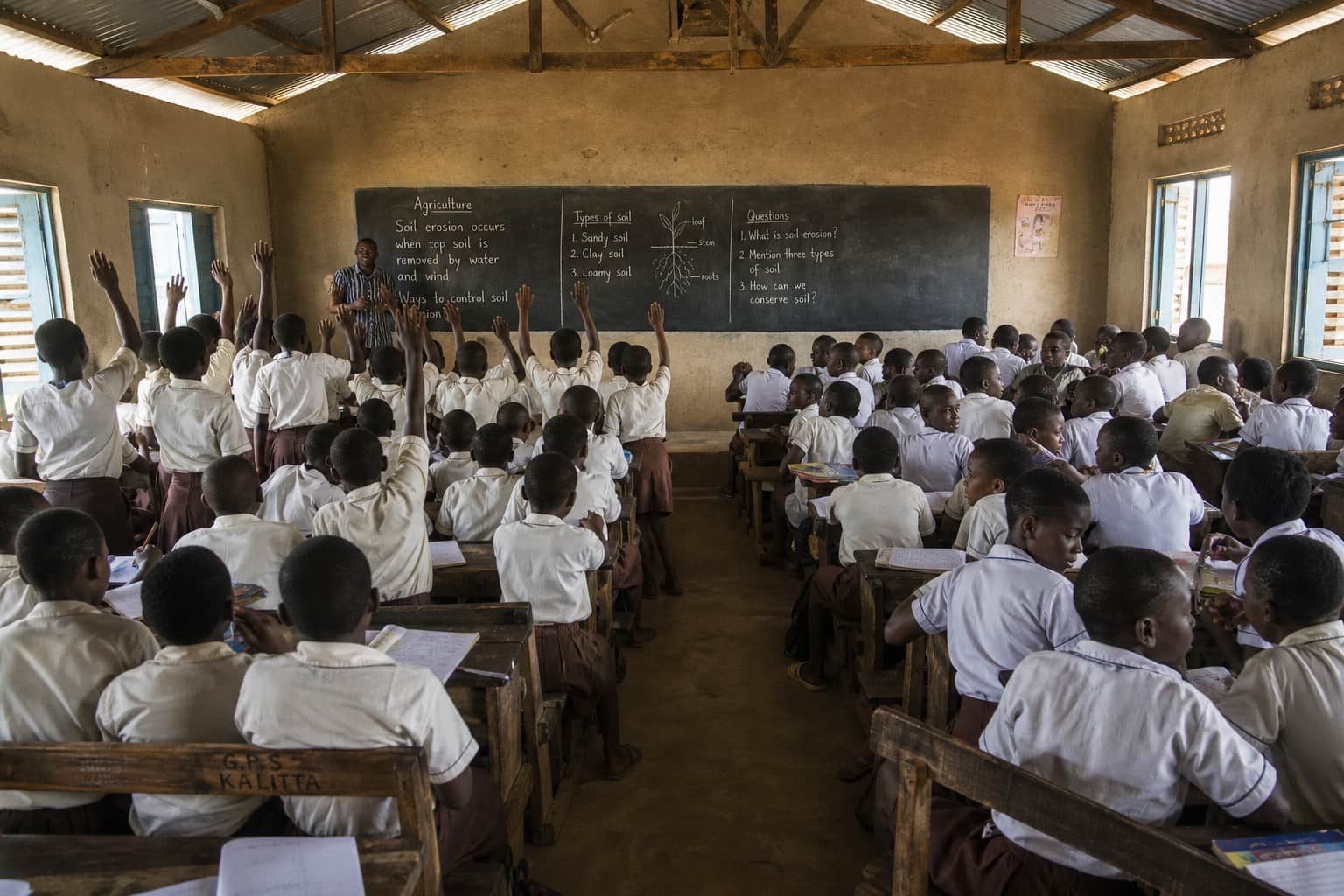 A classroom where students at the front are engaged but students at the back are quiet or distracted